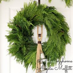 a christmas wreath hanging on the front door