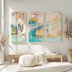 three paintings hanging on the wall in a living room