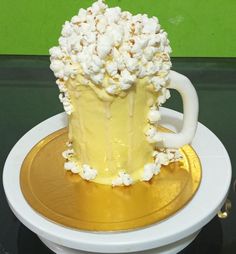 there is a cake that looks like popcorn on top of a plate with gold rims