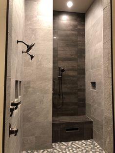 a walk in shower sitting next to a tiled floor