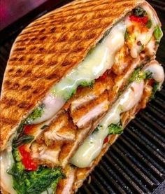 a grilled chicken sandwich on top of a grill