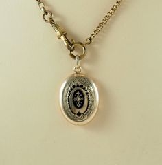 A charming antique Victorian oval mourning locket back pendant. In 8k gold, acid tested, the locket is decorated to the front with chasing and black enamel lozenges.   The reverse panel with machine engraving. Opening to reveal space for two photographs with two gilt frames and both glass coverings, one badly damaged, see photographs. The chain is for display only. Germany 1880s. Space for photographs 2.2cm x 1.5cm.  In inches 7/8" x 1/2". The locket 2.7cm x 2.1cm.  In inches just over  1" x 6/8 Vintage Oval Jewelry With Engraving Option, Antique Gold Victorian Locket Necklace, Antique Oval Pendant Jewelry With Antique Finish, Victorian Locket Necklace With Oval Pendant, Antique Engraved Oval Locket Necklace, Victorian Style Locket Necklace With Oval Pendant, Victorian Antique Gold Oval Locket Necklace, Victorian Oval Necklaces With Antique Finish, Victorian Jewelry With Antique Finish Oval Pendant