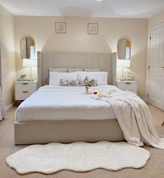 a bedroom with a large bed and white sheets