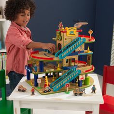 The KidKraft Wash n Go Wooden Car Garage was a Toy of the Year Awards finalist in 2017. Packed with interactive fun, this playset will keep kids engaged and having imaginative fun for hours. Kids can take the included wooden cars up the elevator to the top floor where a helicopter waits on its pad. Zoom down the ramps past the mechanic’s shop and smiling townsfolk to the car wash with its spinning brushes. Fuel up at the gas station, then it’s back to the elevator to do it all again. This playse Wooden Car Garage, Toy Race Track, Play Teepee, Mechanic Shop, Wooden Playset, Wash N Go, Wooden Easel, Wooden Car, Wash And Go