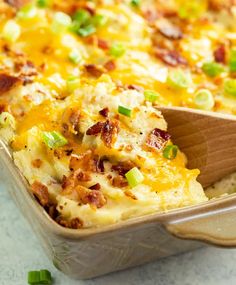 a casserole dish with green onions and bacon