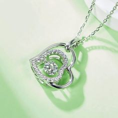 An eye-catching round moissanite dances with ease at the center of this appealing women's necklace, expressing your unstoppable love. Additional round gem set in sterling silver frame the center. Features Moissanite was originally found in meteorites(Chemical name: Silicon Carbide). It was first discovered in 1893, while a scientist was examining meteor samples from a crater in Arizona. After many years, the experts has been recreated moissanite in the laboratory, that make the gemstone with fri Pave Necklace, Women's Necklace, Silicon Carbide, Moissanite Necklace, Moissanite Jewelry, Round Moissanite, Double Heart, Timeless Jewelry, Stone Cuts