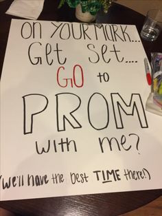 a sign that says, on your mark get set go to prom with me? we'll have the best time here