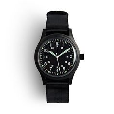 In the 1960s, the U.S. government created military specifications for what would become some of the most iconic timepieces ever. MWC spent countless hours studying some of these legendary watches and built the GG-W-113, named after the government designation for the watch spec issued to military pilots during the Vietnam War. The best recreation of a classic Vietnam-era timepiece you'll find, the watch features a classic black dial with an inner ring to mark 24-hour time and 60-second increments Retro Watches, Nato Strap, Military Watches, The Government, The 1960s, Black Watch, Pilots, Stainless Steel Case, Time Piece