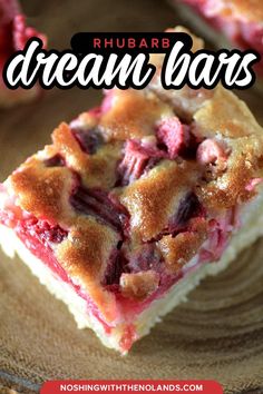 a close up of a piece of cake on a plate with the words rhubarb dream bars above it