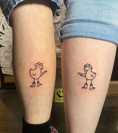 two people with matching tattoos on their legs