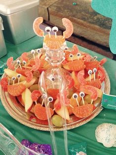 a plate with oranges, apples and candies in the shape of antlers