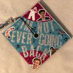 a graduation cap decorated with pictures of the same person and words that say never going back