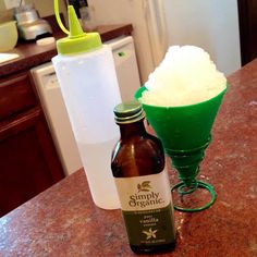 a bottle of beer sitting on top of a counter next to an ice cream cone