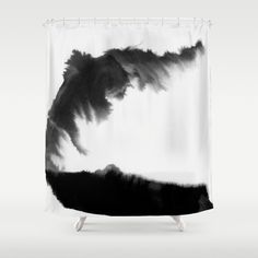 a black and white shower curtain with an abstract painting on the back side of it