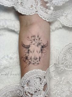 a woman's leg with a cow tattoo on it