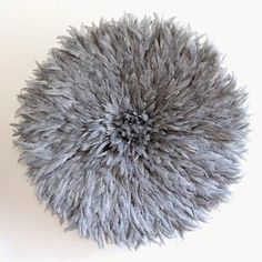 a round gray area rug on a white wall