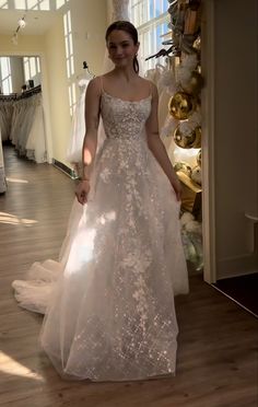 a woman in a wedding dress is posing for the camera