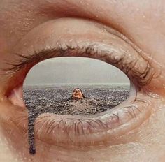 an eye is shown with the reflection of a person in it