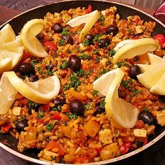 a pan filled with lots of food on top of a table