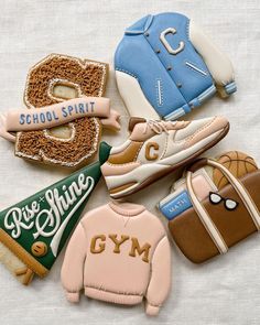 decorated cookies are arranged in the shape of sports shoes, sweaters and gym gear