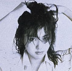 a black and white photo of a woman with wet hair