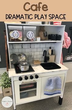 a play kitchen with the words cafe dramatic play space