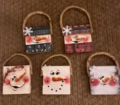 four small bags with snowmen painted on them