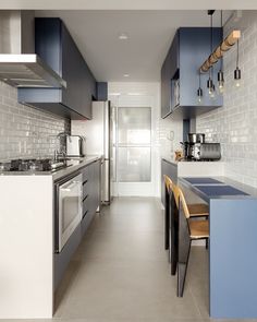 an instagram photo of a kitchen with blue cabinets and counter tops, along with white tiles on the walls