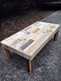 a wooden table sitting on the side of a road