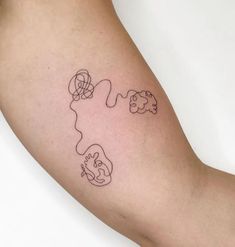 a person with a tattoo on their arm that has an outline of two animals in the shape of a heart