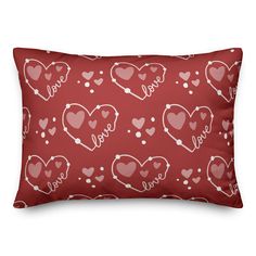 a red pillow with hearts and the word love on it