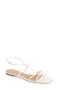 A dainty bow tops the crisscross toe straps of this minimalist ankle-strap sandal that's a perfectly poised option for any occasion. Adjustable ankle strap with buckle closure Leather upper, lining and sole Made in Brazil Spring Ankle Strap T-strap Sandals With Heel Strap, Spring Adjustable Cross Strap Slingback Sandals, Chic Strappy T-strap Sandals With Adjustable Strap, Elegant Spring T-strap Sandals With Adjustable Strap, Elegant T-strap Sandals With Adjustable Strap For Spring, Chic Sandals With Strap Closure For Summer, Chic Spring Sandals With Strap Closure, Chic Strap Closure Sandals For Spring, Elegant Strappy T-strap Sandals With Buckle