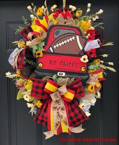 a wreath with a football on it that says kc chiefs and is decorated with flowers