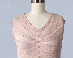 "Beautiful, ethereal 1920s flapper dress with silvery and pink translucent beadwork. Sleeveless, with loose, straight flapper silhouette. Drapey, textured semi sheer palest pink silk. Beadwork is done in rows of arcs that descend from the center front and back and seem to drape about the body. Circles down the front and back with pearl bead centers. Snap shoulder and side closure. LAYAWAY is available for all items, please message me for details. Measurements: Meant to fit loosely. Recommended f 1920s Embellished Sleeveless Flapper Dress, Beaded Flapper Dress, 20s Dresses, 1920 Fashion, 1920s Flapper Dress, 1920s Flapper, 1920s Dress, Pink Beaded, Lancaster Pa