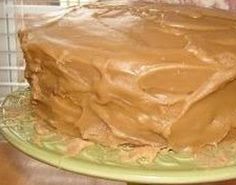 a chocolate cake with frosting on a green plate