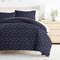 a bed covered in blue and white sheets