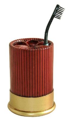 the toothbrush holder is red and gold with a black tooth brush in it's top