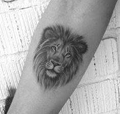 a black and white photo of a lion on the arm