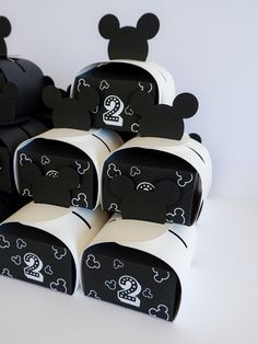 several black and white boxes with mickey mouse faces on them