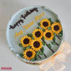 a birthday cake decorated with sunflowers and the words happy birthday, any time here