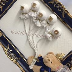 a teddy bear and some white flowers in a frame