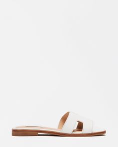 Geometric cutouts on the wide single strap of the HADYN slide give this flat sandal design a fresh feel. Slip-on style Cutout details on strap .75 inch heel height Leather, vegan leather, or textile upper material Synthetic lining Synthetic sock Synthetic sole Imported Sandal Design, Branded Shoes For Men, Steve Madden Store, Leather Wear, Womens Slides, Designer Sandals, Madden Girl, Flat Sandals, Slide Sandals