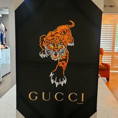 a gucci logo is displayed on the counter in front of an open closet door