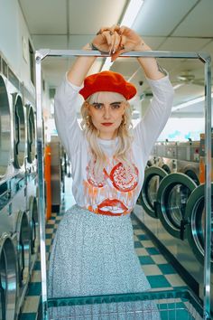 a woman in a red hat is posing for the camera