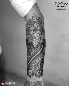 a person's arm with a tattoo on it and an intricate flower in the middle