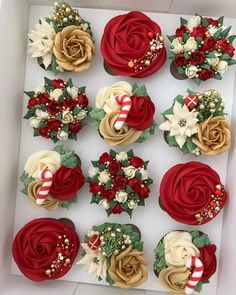 cupcakes decorated with flowers and candy canes in a box