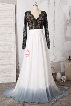 a white and black wedding dress with sheer lace on the bodicer, long sleeves