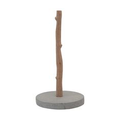 a wooden stick sitting on top of a cement base