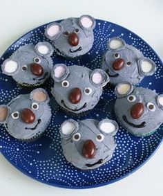 there are cupcakes shaped like koalas on a blue polka dot plate