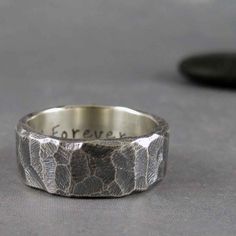 a silver ring with the words forever engraved on it